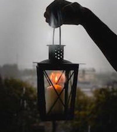 A hand held lantern in the darkness.