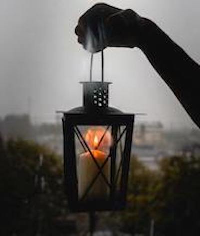 A hand held lantern in the darkness.